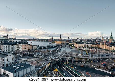 Stock Photo - Bridges, railway tracks, church tower, cityscape and water canal, Stockholm, Sweden. Fotosearch