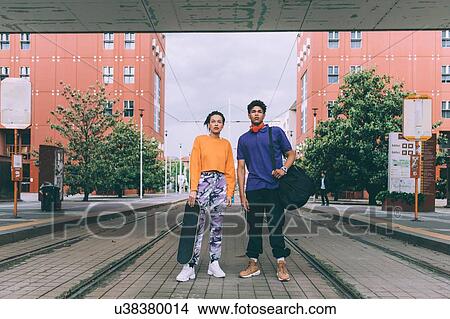Brother and sister standing on tram tracks, Milan, Italy View Large Photo Image Picture - Brother and sister standing on tram tracks, Milan, Italy. Fotosearch