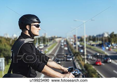 Businessman on bicycle on bridge View Large Photo Image Stock Image - Businessman on bicycle on bridge. Fotosearch