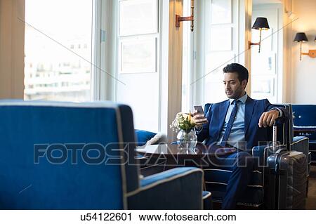 Businessman using smartphone in office View Large Photo Image Stock Image - Businessman using smartphone in office. Fotosearch