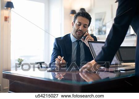 Businessman using smartphone in office View Large Photo Image Stock Photo - Businessman using smartphone in office. Fotosearch