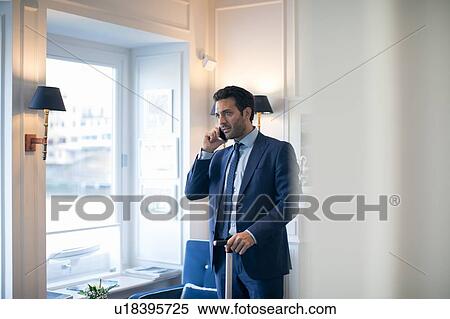 Businessman using smartphone in office View Large Photo Image Stock Photography - Businessman using smartphone in office. Fotosearch