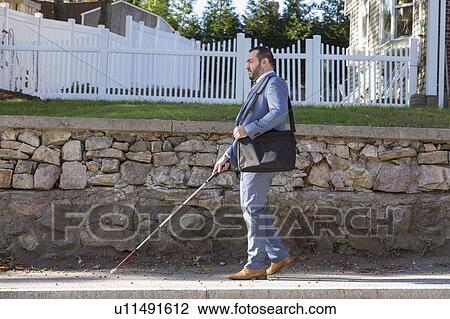 Businessman with visual impairment outside with his cane View Large Photo Image Stock Image - Businessman with visual impairment outside with his cane. Fotosearch
