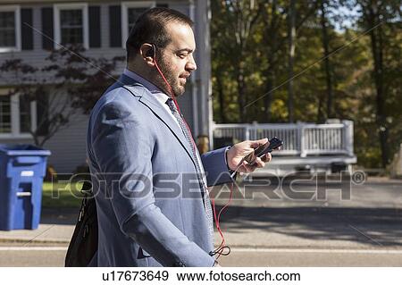 Stock Photo - Businessman with visual impairment using phone. Fotosearch