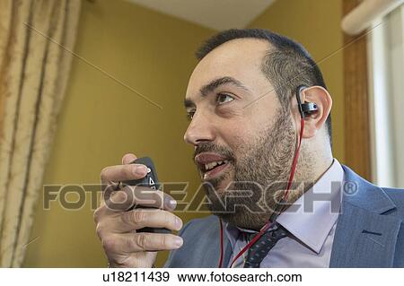 Stock Photo - Businessman with visual impairment using phone. Fotosearch