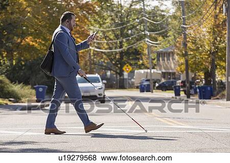 Businessman with visual impairment using phone View Large Photo Image Stock Photo - Businessman with visual impairment using phone. Fotosearch