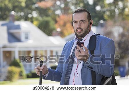 Businessman with visual impairment using phone View Large Photo Image Stock Photo - Businessman with visual impairment using phone. Fotosearch