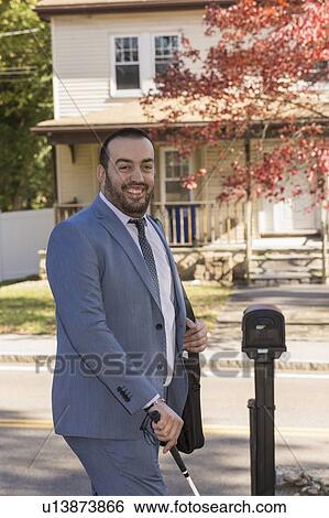 Businessman with visual impairment outside with his cane View Large Photo Image Stock Photograph - Businessman with visual impairment outside with his cane. Fotosearch