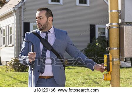 Businessman with visual impairment crossing the street View Large Photo Image Stock Photograph - Businessman with visual impairment crossing the street. Fotosearch