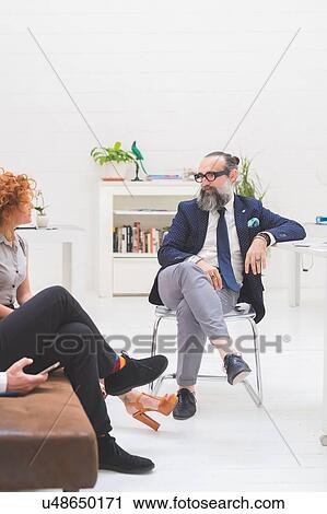 Businessmen and woman having discussion at meeting on office sofa, cropped View Large Photo Image Stock Image - Businessmen and woman having discussion at meeting on office sofa, cropped. Fotosearch