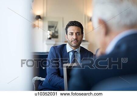 Businessmen meeting in office View Large Photo Image Stock Image - Businessmen meeting in office. Fotosearch