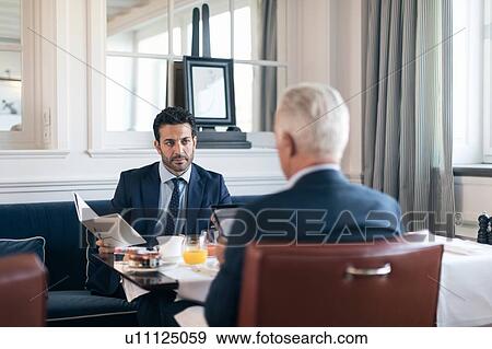 Businessmen talking in restaurant View Large Photo Image Stock Photo - Businessmen talking in restaurant. Fotosearch