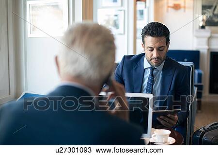 Businessmen using digital tablet and laptop in office View Large Photo Image Stock Image - Businessmen using digital tablet and laptop in office. Fotosearch