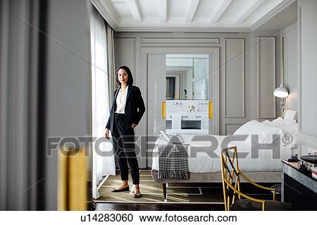 Businesswoman beside window in suite View Large Photo Image Stock Image - Businesswoman beside window in suite. Fotosearch