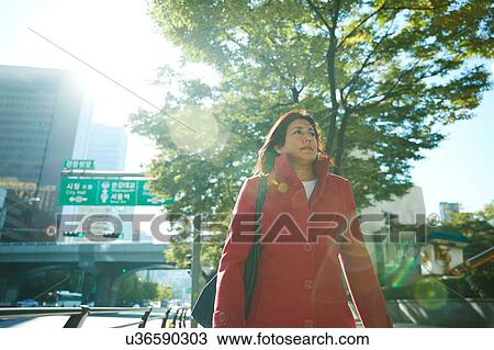 Stock Image - Businesswoman exploring city, Seoul, South Korea. Fotosearch