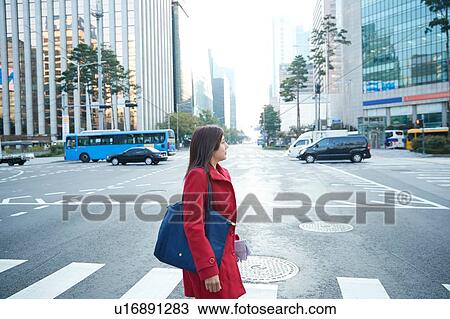 Businesswoman on pedestrian crossing in city, Seoul, South Korea View Large Photo Image Stock Image - Businesswoman on pedestrian crossing in city, Seoul, South Korea. Fotosearch