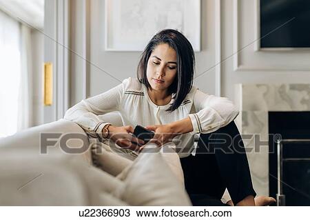 Businesswoman using smartphone in suite View Large Photo Image Stock Image - Businesswoman using smartphone in suite. Fotosearch