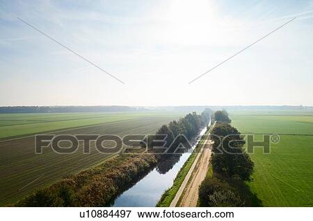 Canal cutting through field landscape, elevated view, Netherlands View Large Photo Image Stock Photo - Canal cutting through field landscape, elevated view, Netherlands. Fotosearch