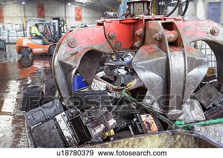 Car batteries with crane grab in vehicle battery recycling plant View Large Photo Image Stock Photo - Car batteries with crane grab in vehicle battery recycling plant. Fotosearch