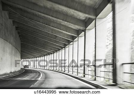 Stock Photography - Car driving through covered highway with pillars, Bolzano, Trentino Alto Adige, Italy. Fotosearch