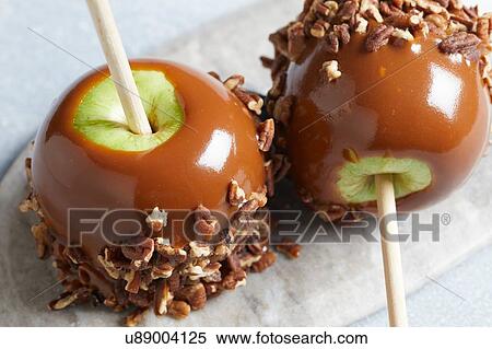 Stock Photography - Caramel apples with pecans. Fotosearch