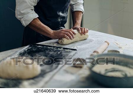 Stock Photo - Chef kneading pastry dough. Fotosearch