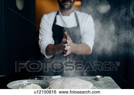 Stock Photograph - Chef working with pastry dough. Fotosearch