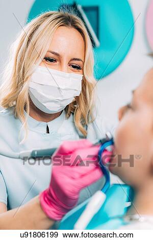 Child dentistry. Female dentist working with school boy. View Large Photo Image Stock Photo - Child dentistry. Female dentist working with school boy.. Fotosearch