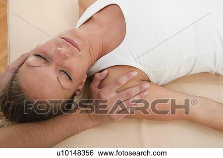 Stock Photograph - Chiropractic neck adjustment. Fotosearch
