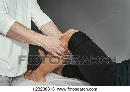 Chiropractor treating knee View Large Photo Image Stock Image - Chiropractor treating knee. Fotosearch