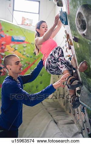 Climber guiding friend on climbing wall View Large Photo Image Picture - Climber guiding friend on climbing wall. Fotosearch