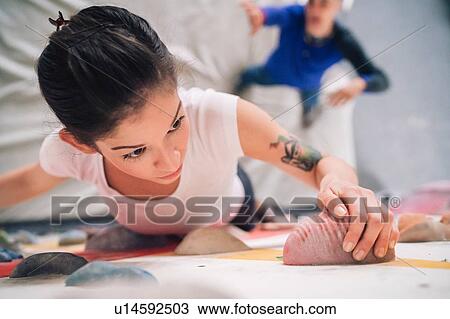 Climber guiding friend on climbing wall View Large Photo Image Stock Image - Climber guiding friend on climbing wall. Fotosearch