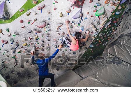 Climber guiding friend on climbing wall View Large Photo Image Stock Photo - Climber guiding friend on climbing wall. Fotosearch