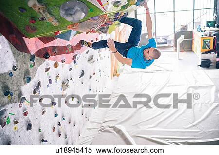 Climber on climbing wall View Large Photo Image Stock Photography - Climber on climbing wall. Fotosearch