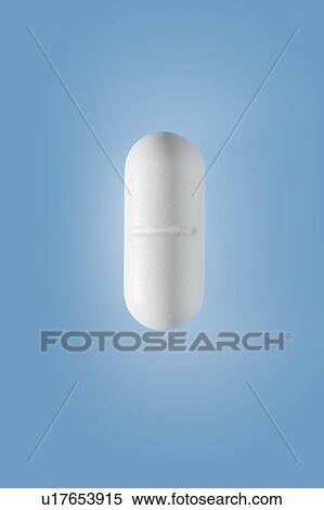 Stock Photography - Close-up of one white pill on a blue background. This is paracetamol, a painkiller.. Fotosearch