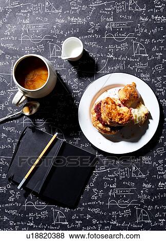Stock Photo - Coffee, breakfast biscuit with raspberry jam on blackboard background, overhead view. Fotosearch