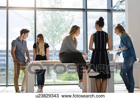 Colleagues brainstorming by glass wall View Large Photo Image Stock Image - Colleagues brainstorming by glass wall. Fotosearch