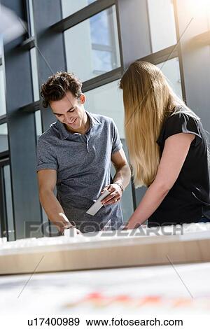 Colleagues brainstorming by glass wall View Large Photo Image Stock Photo - Colleagues brainstorming by glass wall. Fotosearch