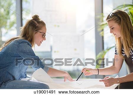 Colleagues brainstorming over charts in bright sunlight View Large Photo Image Stock Image - Colleagues brainstorming over charts in bright sunlight. Fotosearch