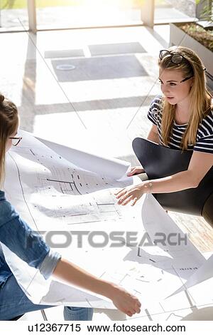 Colleagues brainstorming over charts in bright sunlight View Large Photo Image Stock Photography - Colleagues brainstorming over charts in bright sunlight. Fotosearch
