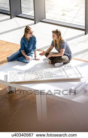 Colleagues brainstorming over architectural model View Large Photo Image Stock Photo - Colleagues brainstorming over architectural model. Fotosearch