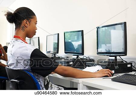 Stock Image - College student studying in classroom. Fotosearch