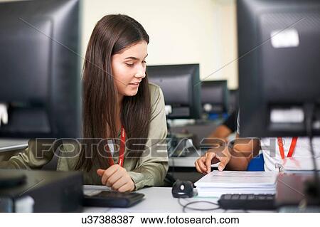 Stock Photo - College students studying with computer in classroom. Fotosearch