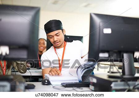 Stock Photo - College students studying with computer in classroom. Fotosearch