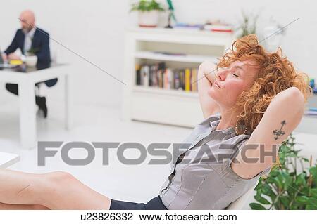 Cool businesswoman with eyes closed and feet up in office View Large Photo Image Stock Image - Cool businesswoman with eyes closed and feet up in office. Fotosearch
