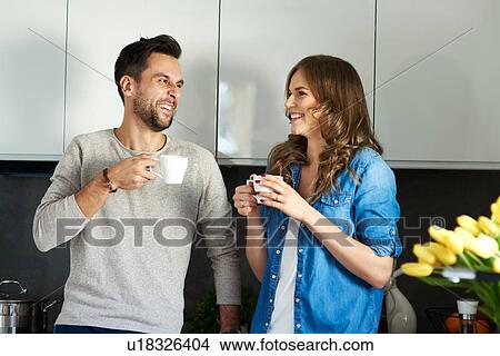 Couple drinking coffee in kitchen View Large Photo Image Picture - Couple drinking coffee in kitchen. Fotosearch