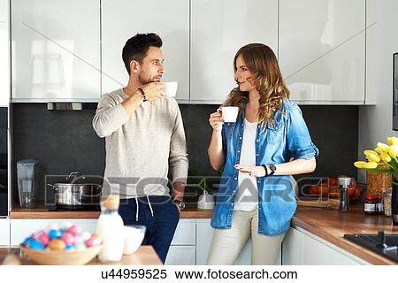 Couple drinking coffee in kitchen View Large Photo Image Stock Photography - Couple drinking coffee in kitchen. Fotosearch