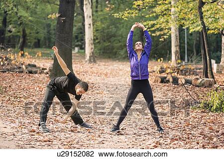 Couple exercising in park View Large Photo Image Stock Image - Couple exercising in park. Fotosearch