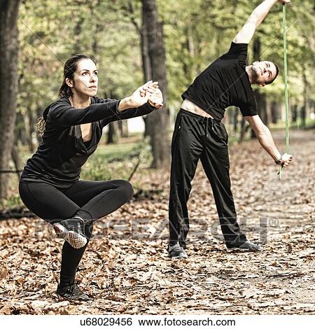 Couple exercising in park View Large Photo Image Stock Photograph - Couple exercising in park. Fotosearch