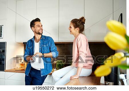 Couple talking in kitchen View Large Photo Image Stock Image - Couple talking in kitchen. Fotosearch